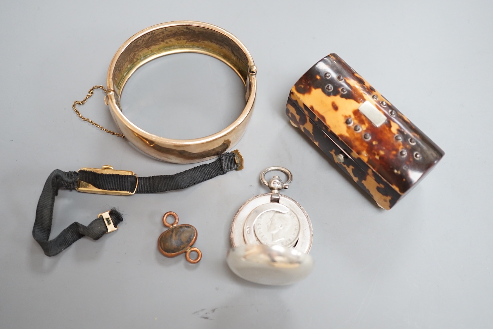 A group of mixed collectables including a George V silver sovereign case, a tortoiseshell small box, a gold plated bangle and a lady's small 18ct gold manual wind wrist watch, etc.